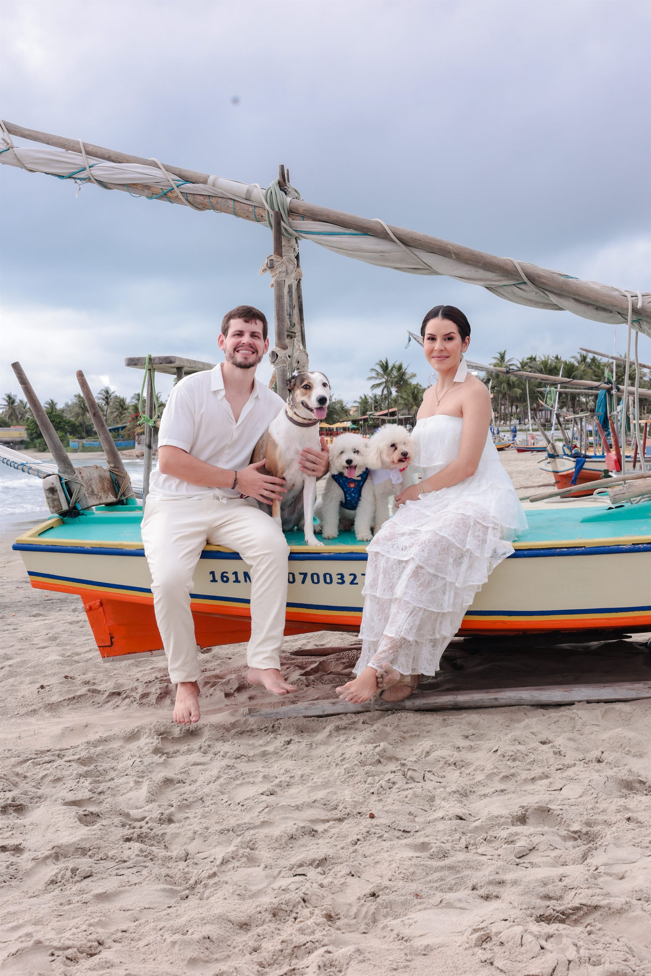 Ary e Érico sentados em um barco colorido com os cachorros